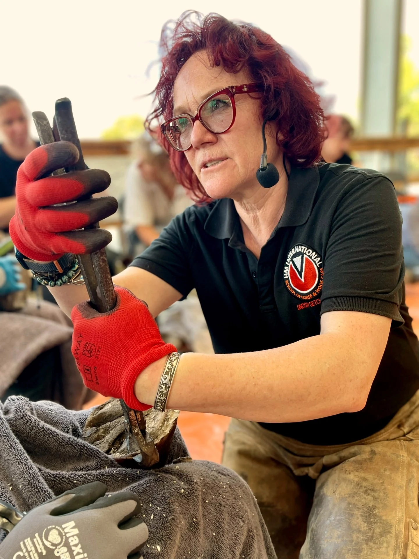 Lindsay Setchell teaching hoof work with a headset microphone