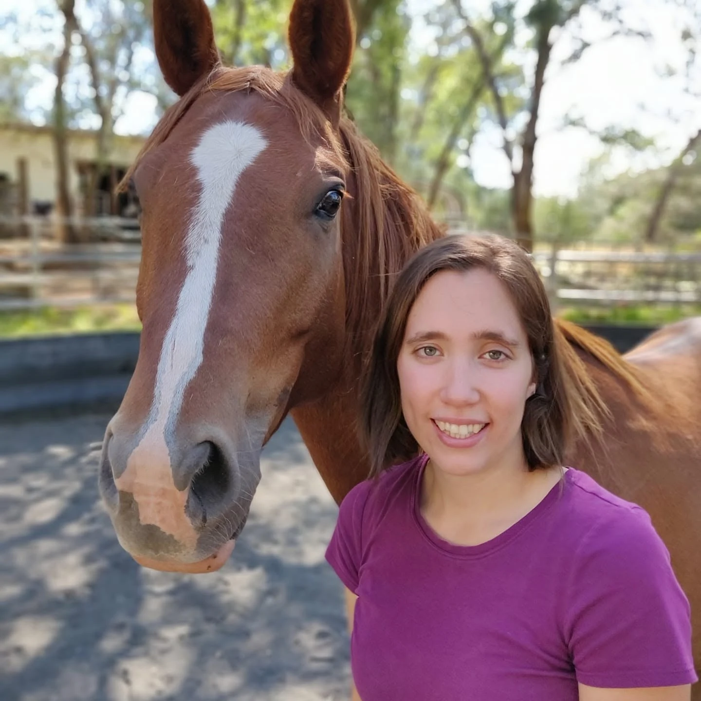 Laura standing beside her chestnut horse